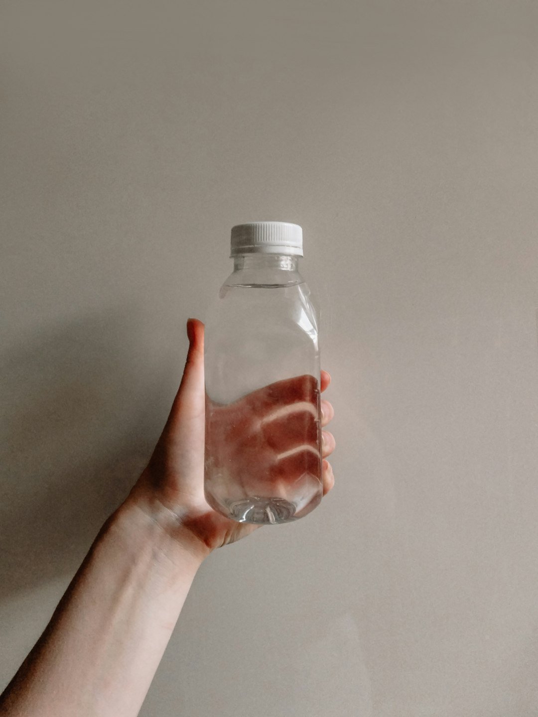 a hand holding a bottle