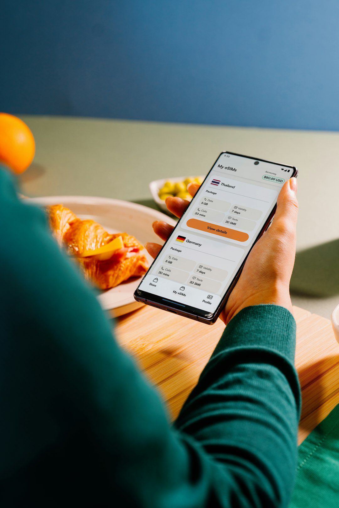 Person using phone with currency exchange rates