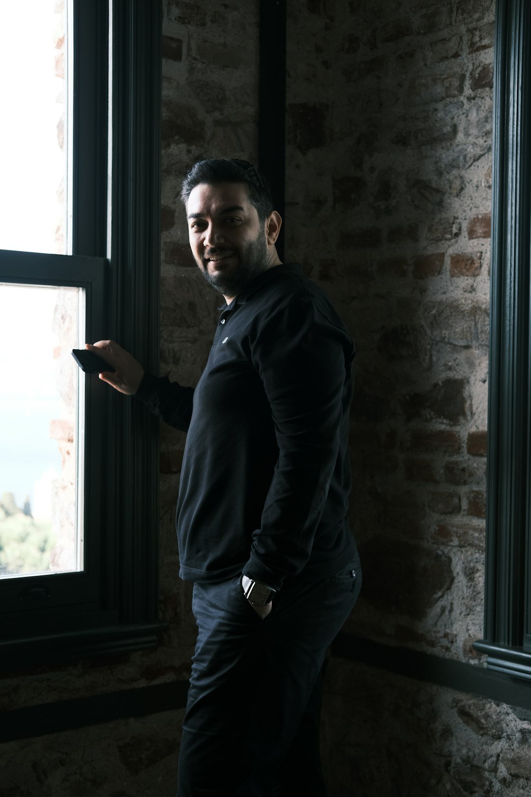 a man standing in front of a window