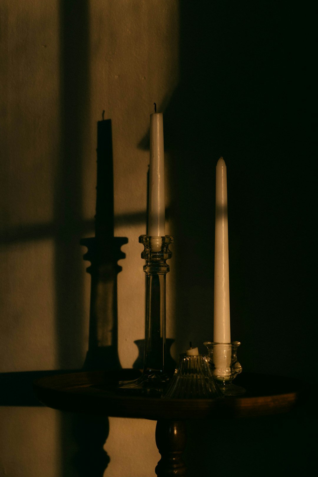 A table topped with two candles and a candle holder