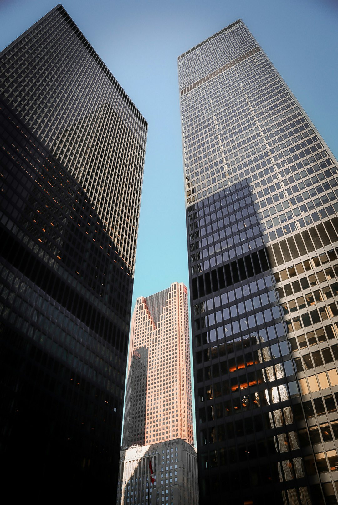 Modern skyscrapers reaching towards a clear blue sky