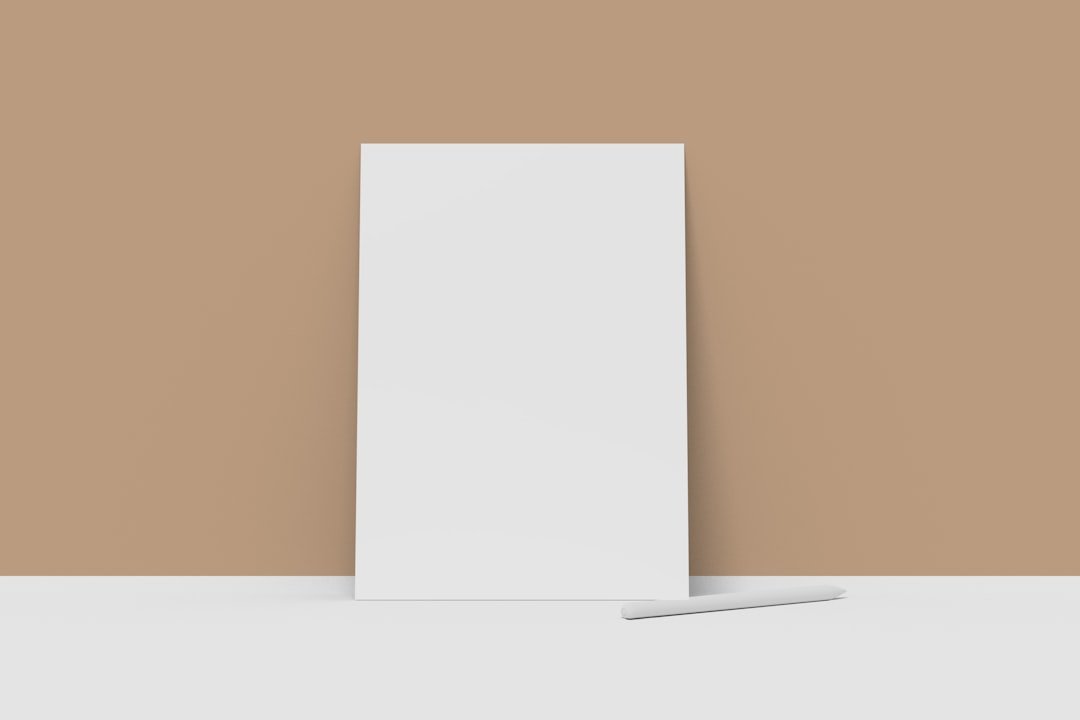 A tall white object stands against a tan wall