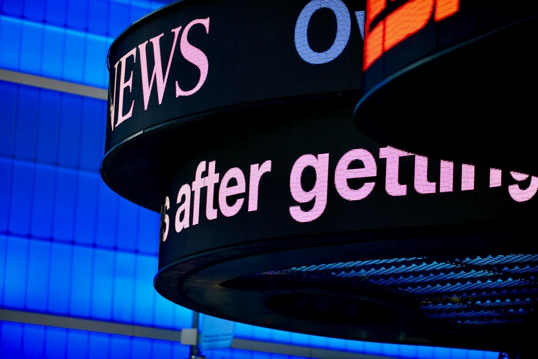 a close up of a sign with a building in the background