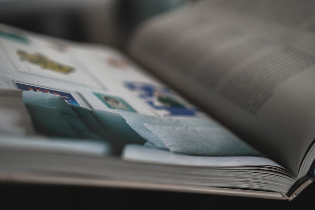 An open book contains colorful stamps.