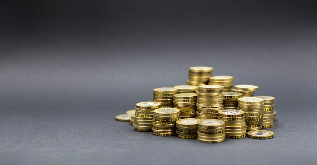 A pile of gold coins on a dark background