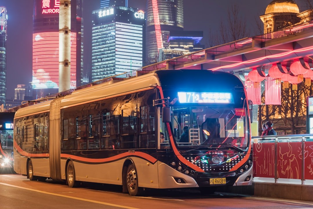 red and blue double decker bus on road during daytime