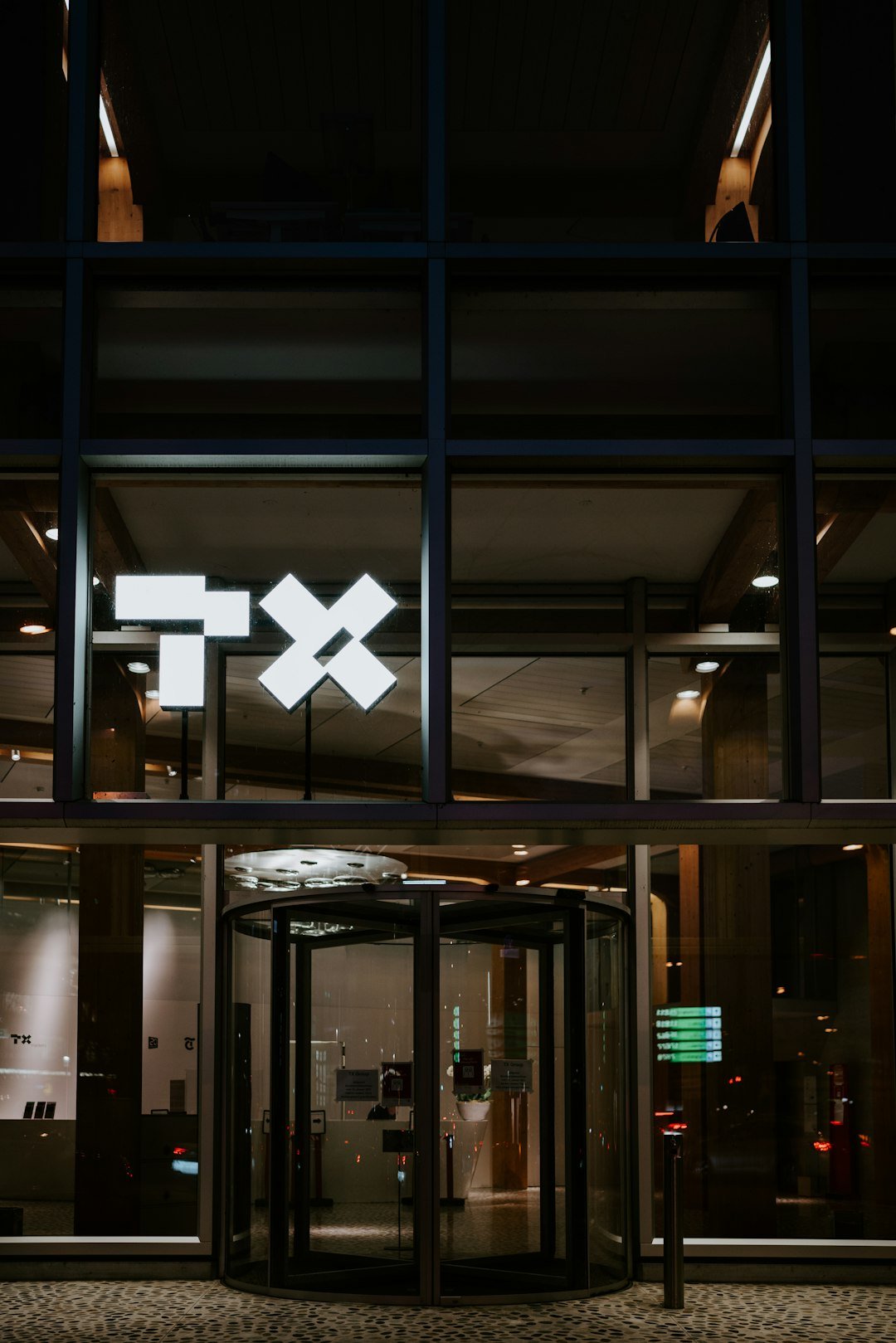 a building with a lit up exit way at night