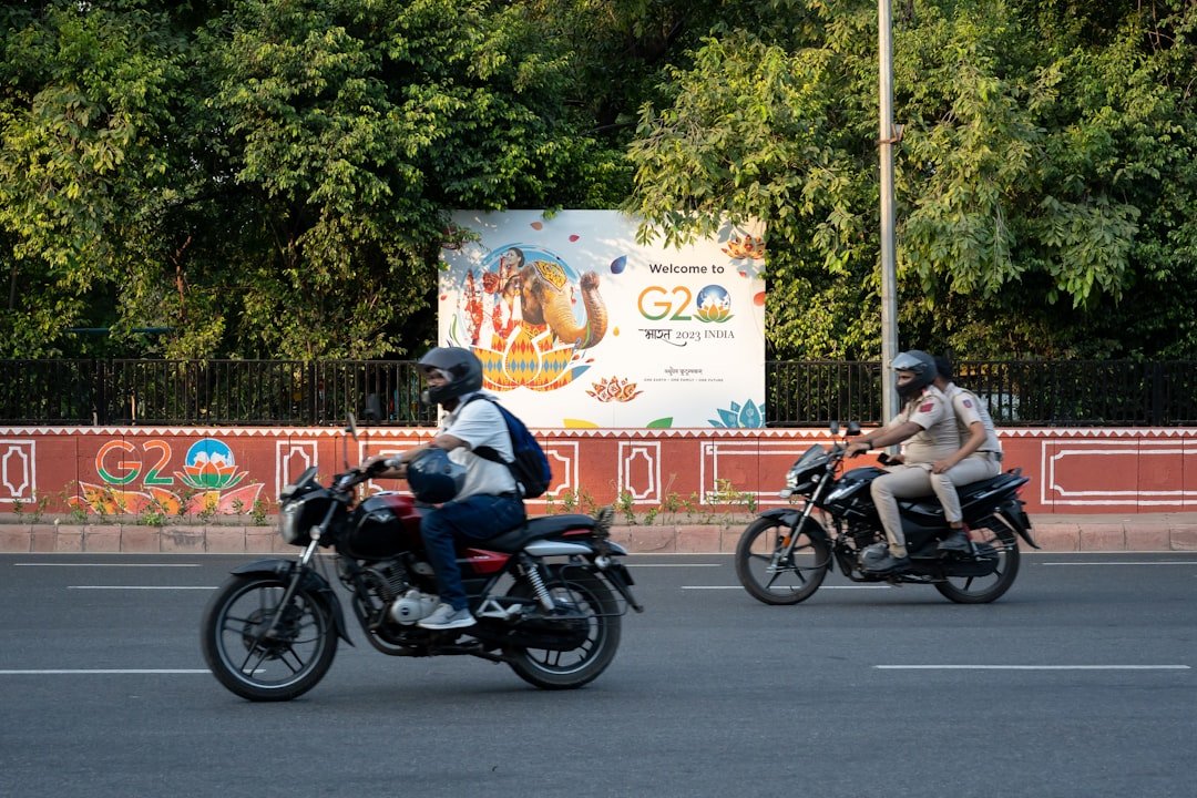 a couple of people riding motorcycles down a street