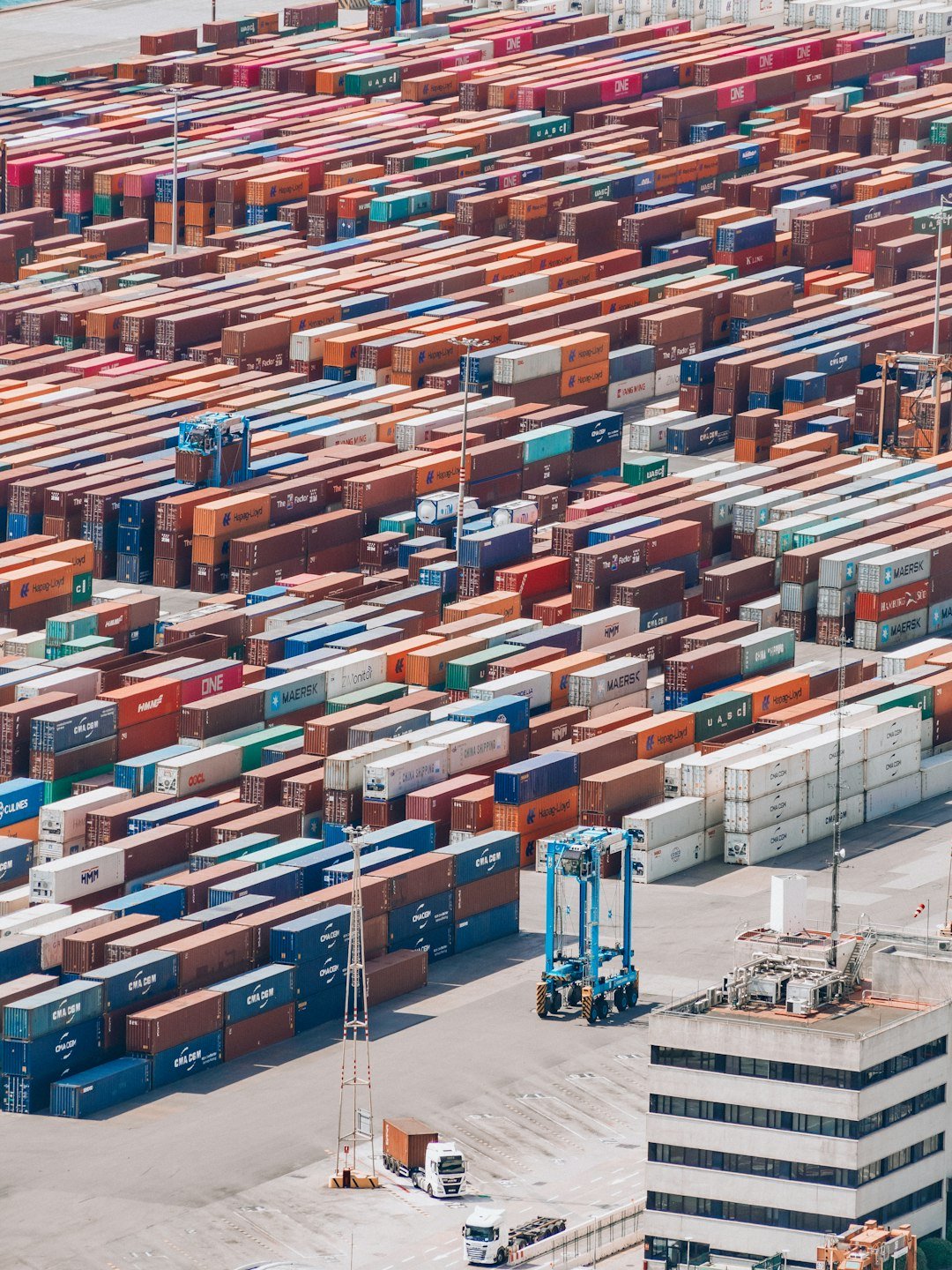 a large amount of cargo containers are stacked together