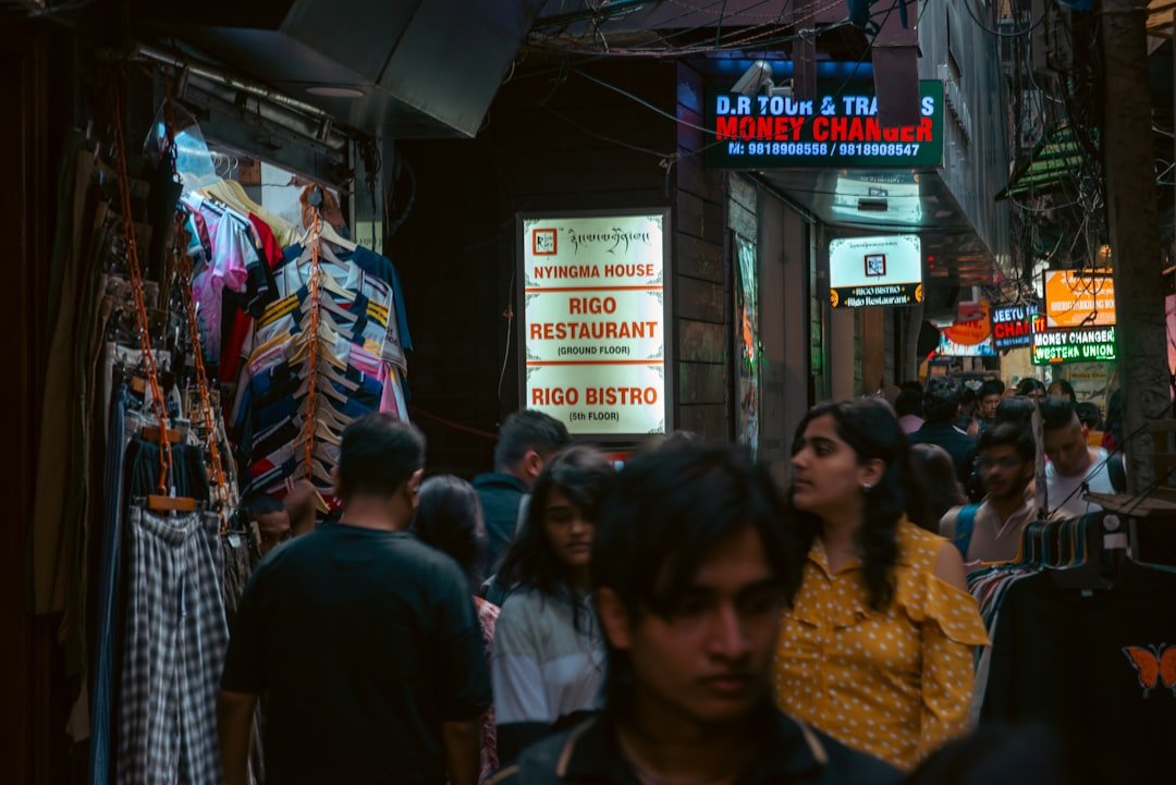 Crowded street market with shops and people.