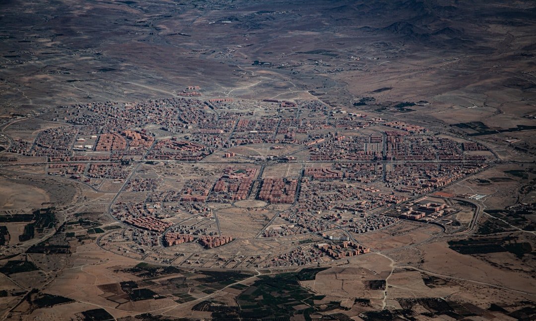 Aerial view of a densely populated town with red roofs.
