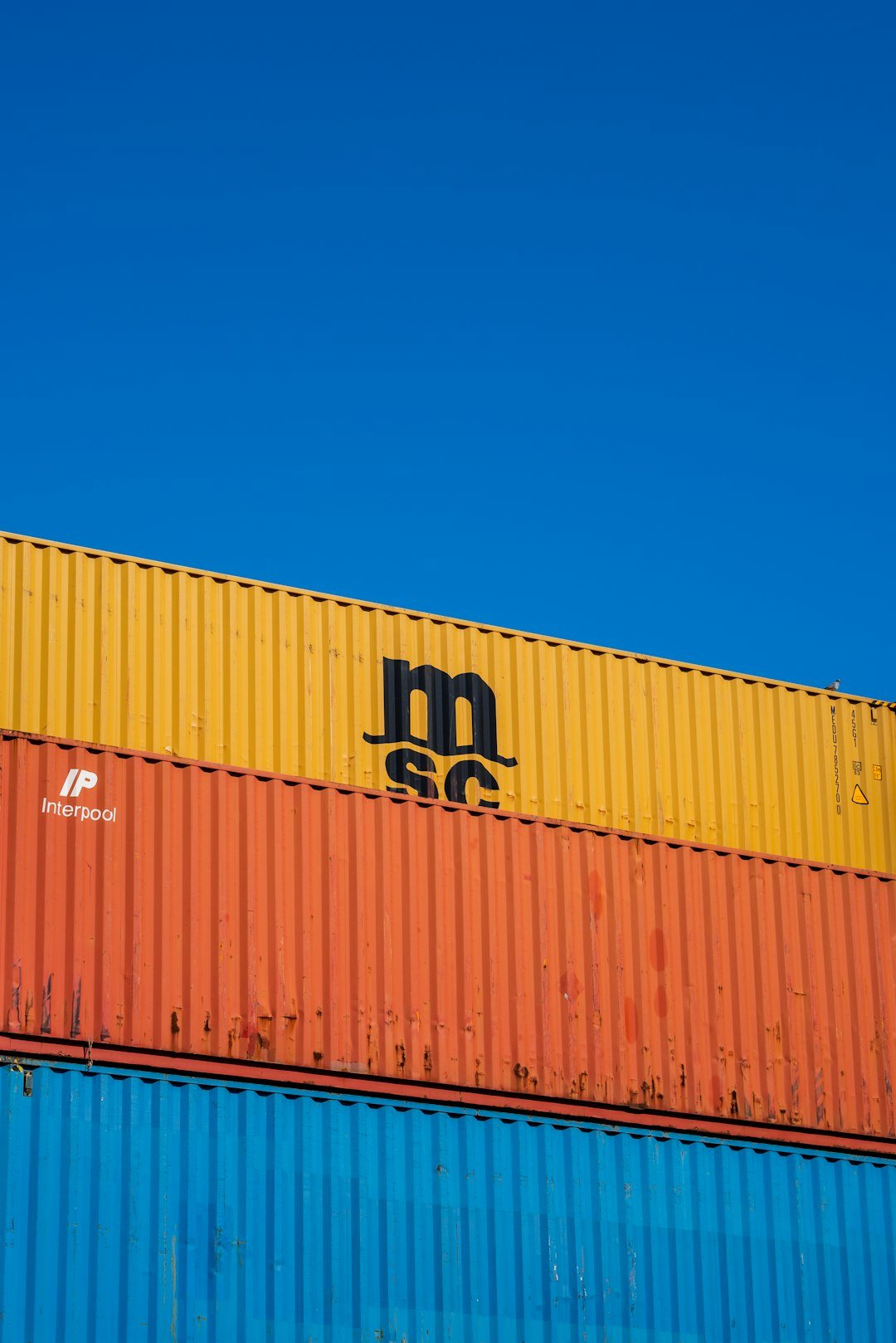 a blue sky with a yellow and orange container on top of it