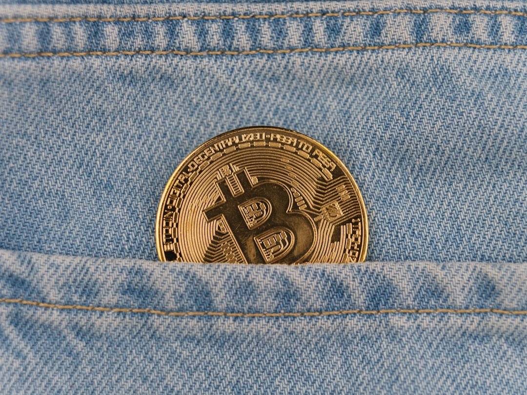 a bitcoin in the back pocket of a pair of jeans