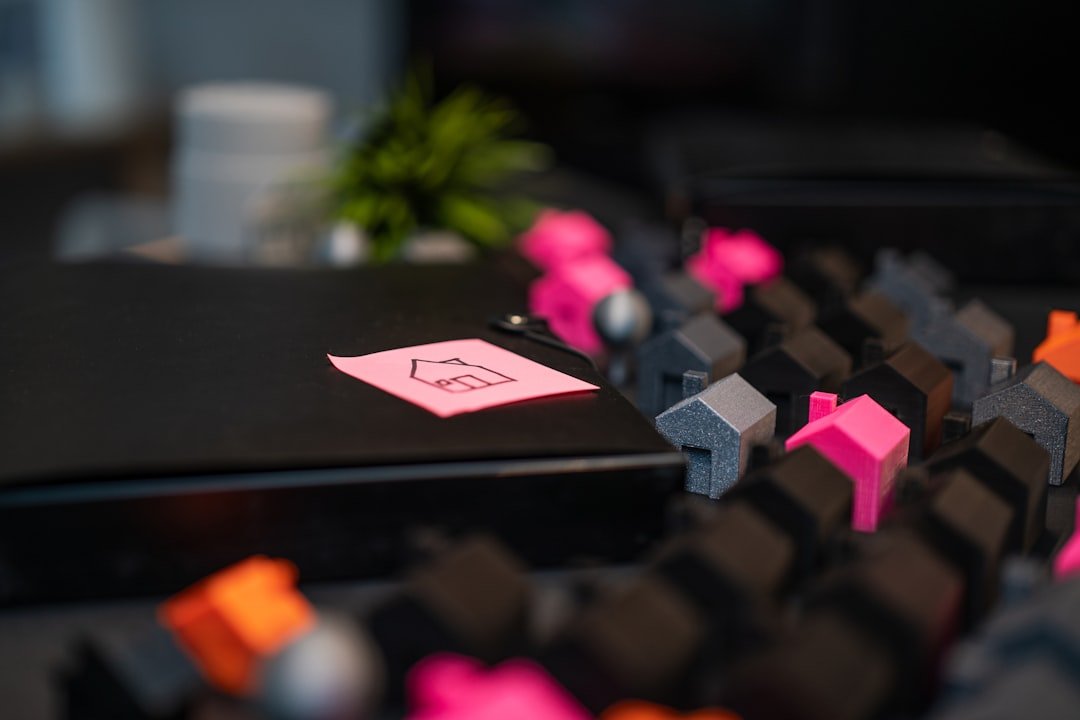 Pink sticky note with house drawing on desk