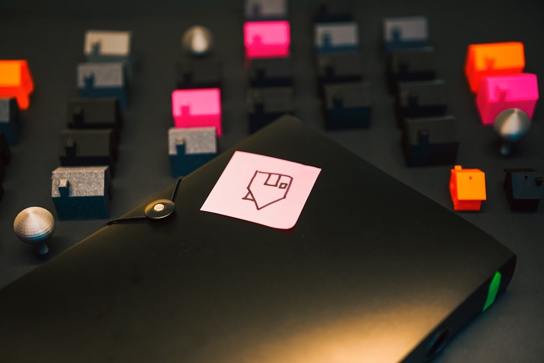 A black folder with a sticky note attached.