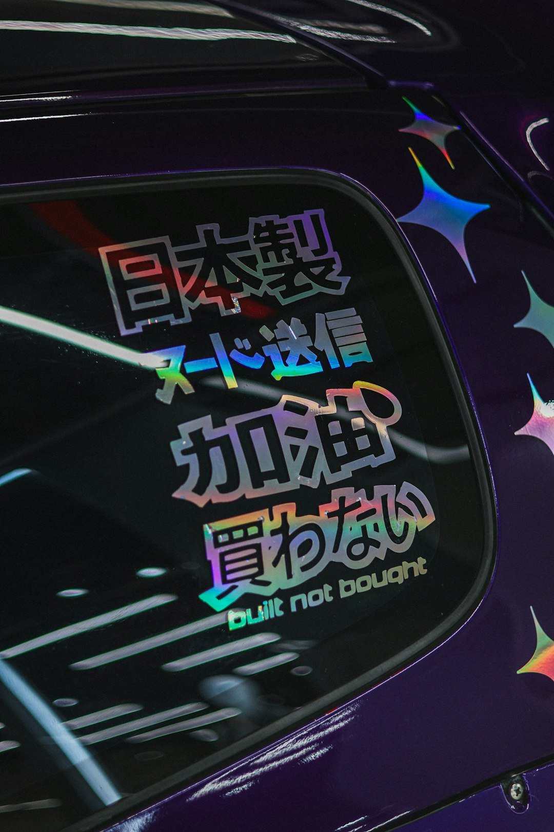 Japanese text and stars sticker on purple car window