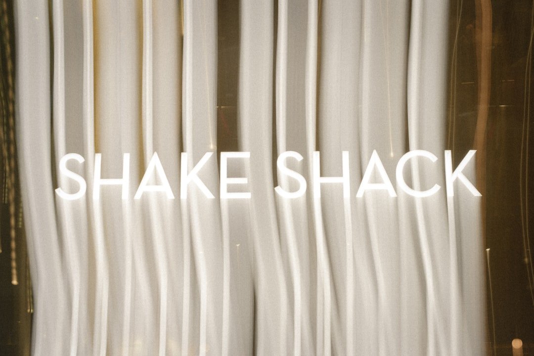A close up of a white curtain with the words shake shack on it