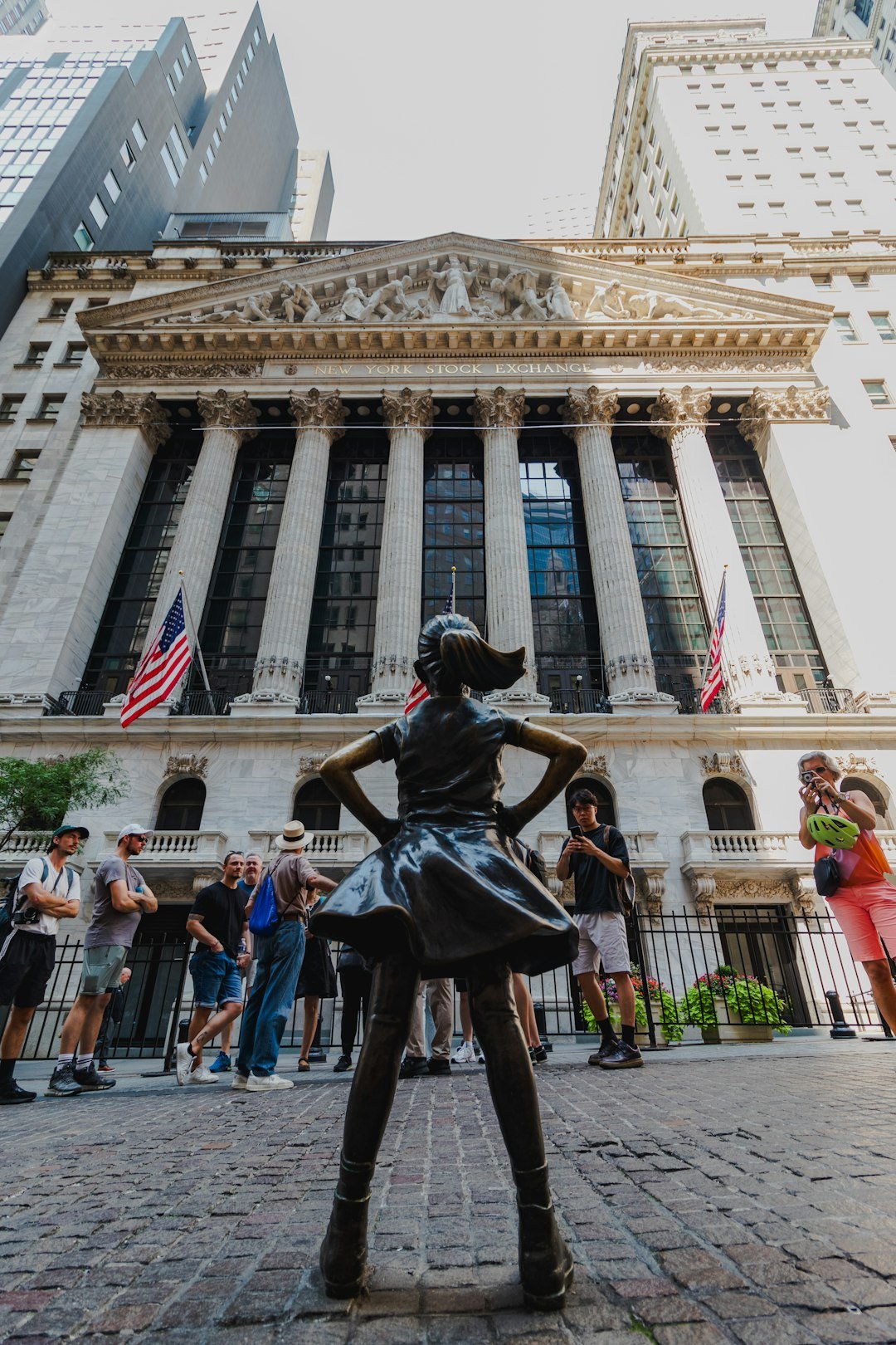 A statue of a woman standing in front of a building