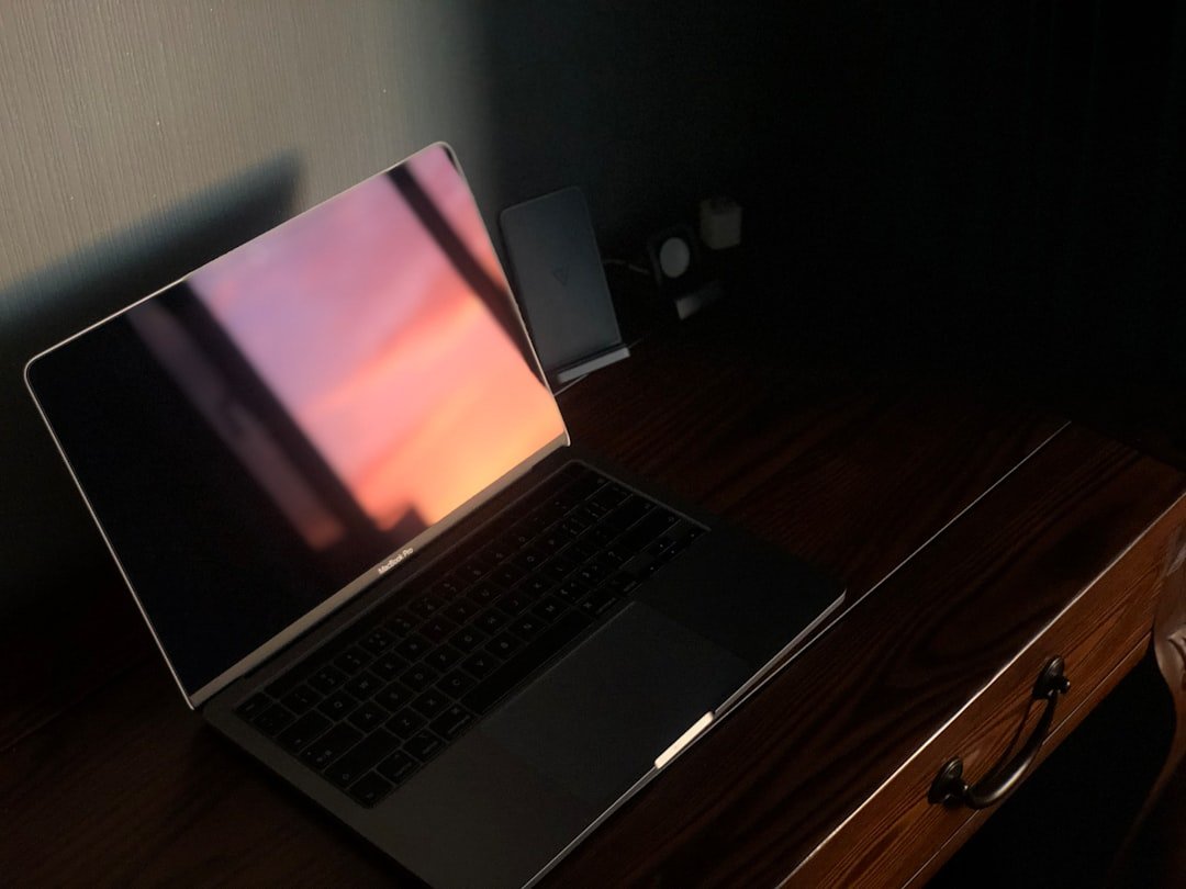 a laptop computer sitting on top of a wooden desk