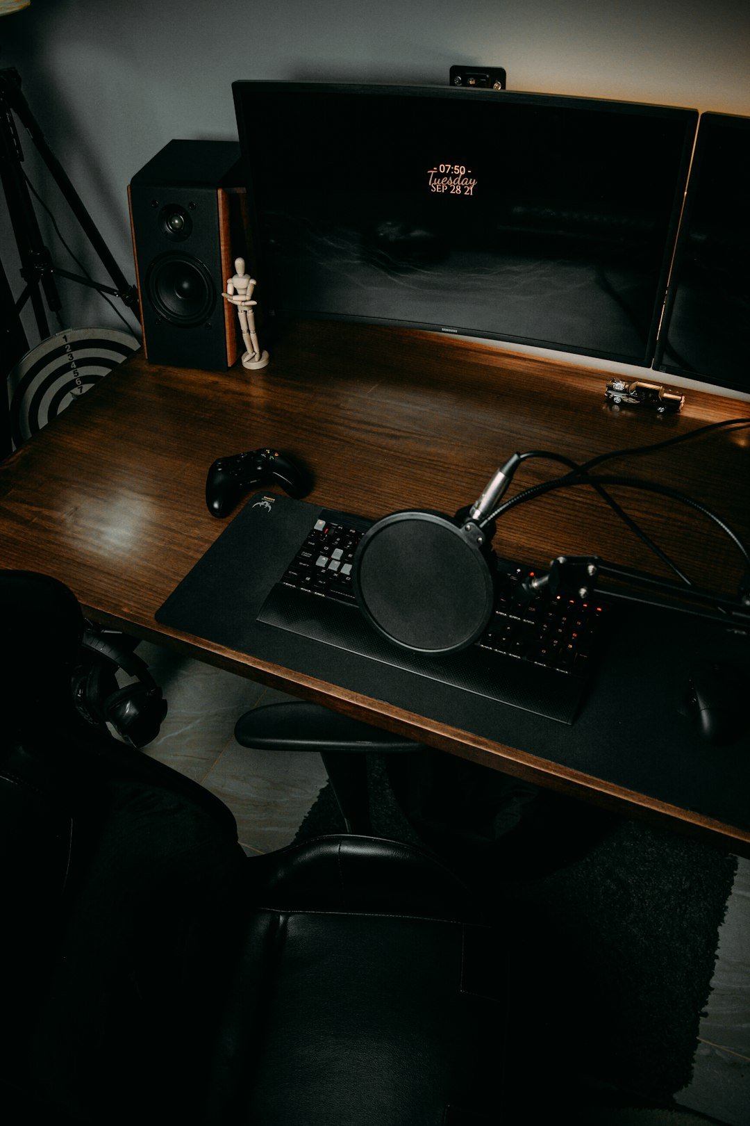 a desk with a keyboard and speakers on it
