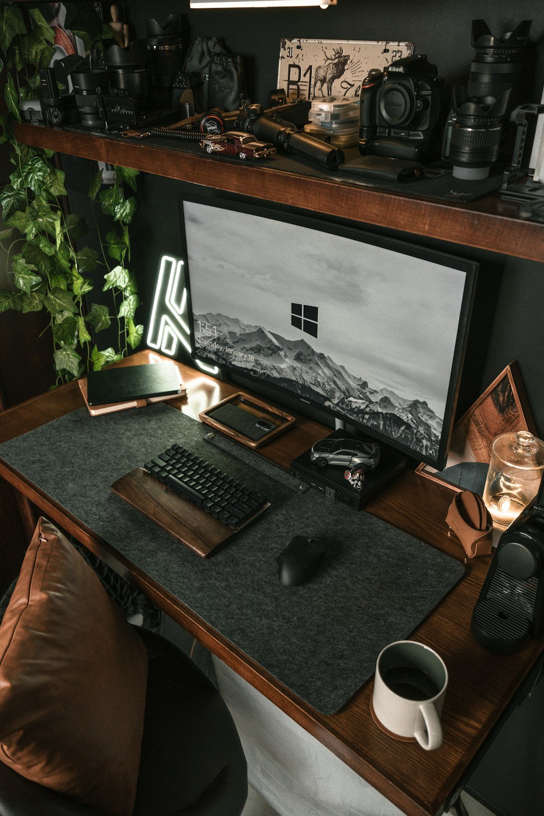 a desk with a monitor, keyboard and mouse