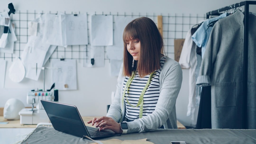 A fashion designer is working on her laptop.