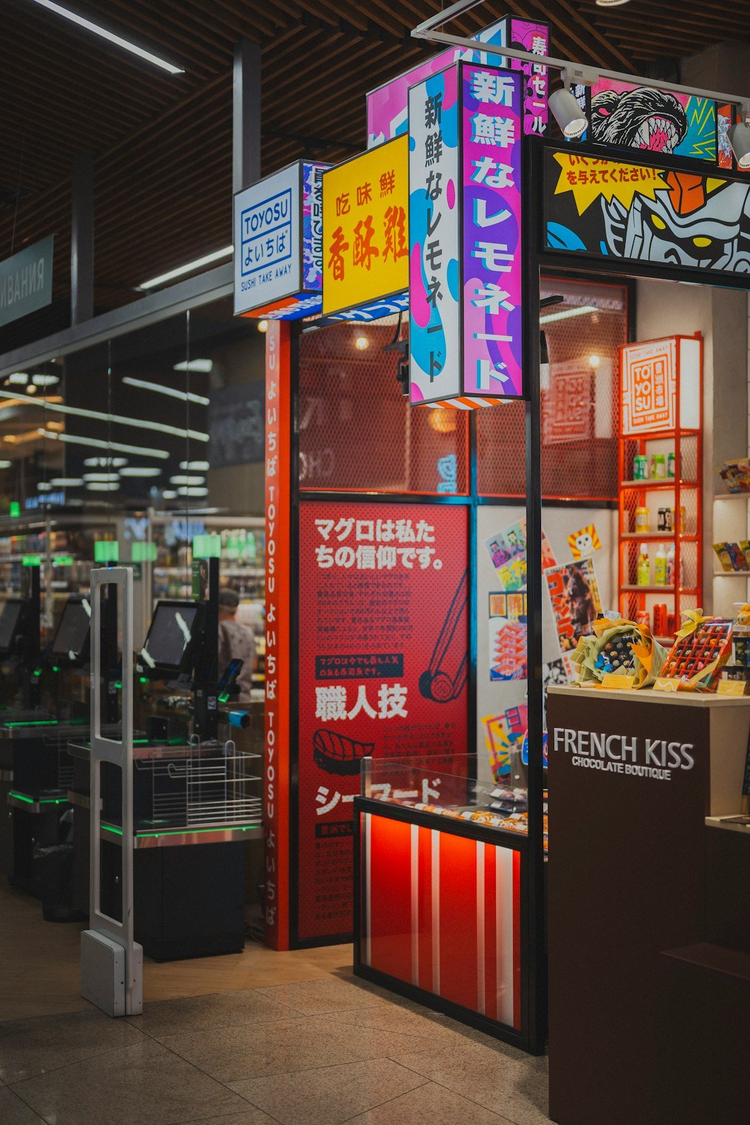 Brightly lit japanese food stall in a modern market.