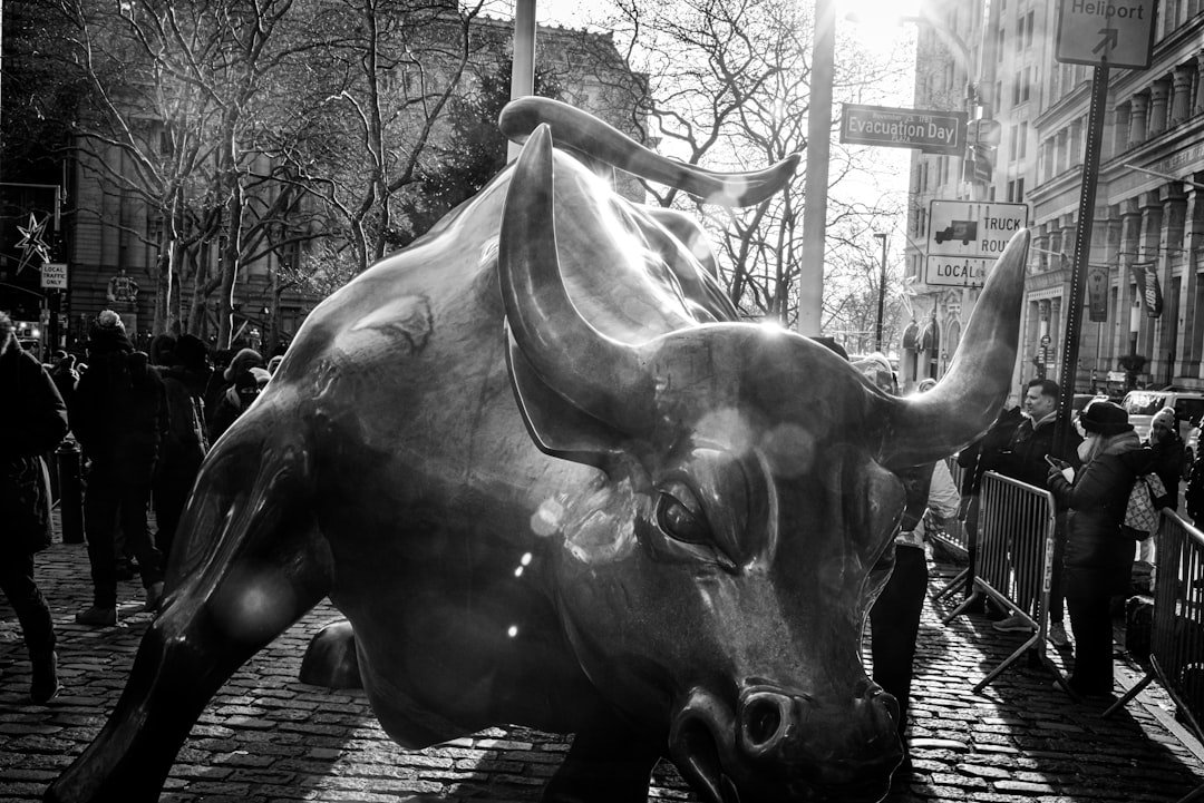 a statue of a bull on a city street