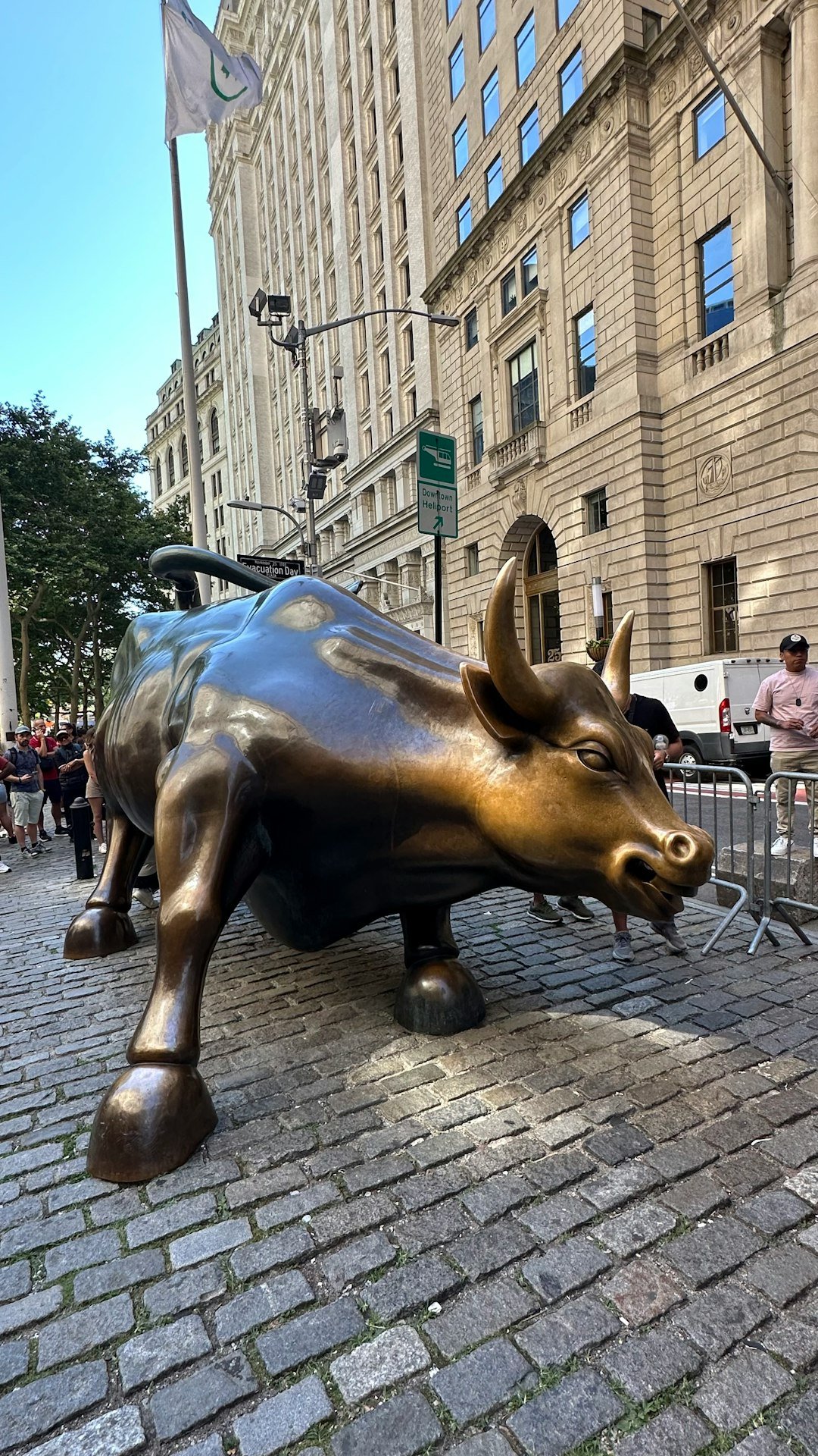 A statue of a bull on a brick sidewalk