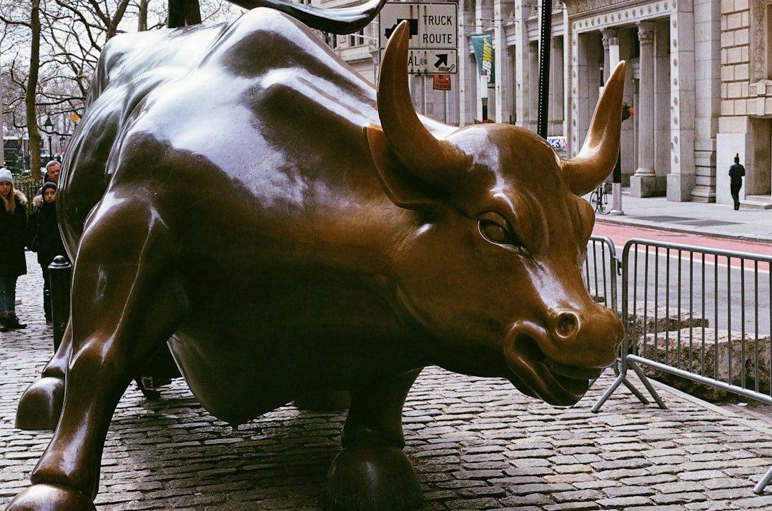 A statue of a bull on a city street