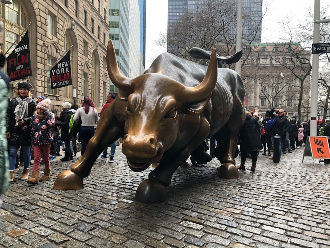 a statue of a bull on a brick street