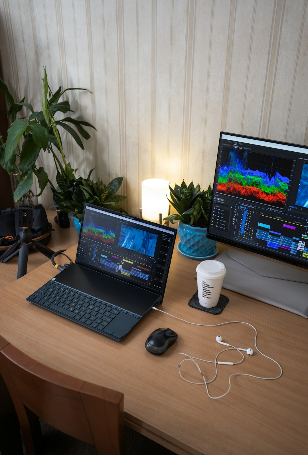 A laptop computer sitting on top of a wooden desk